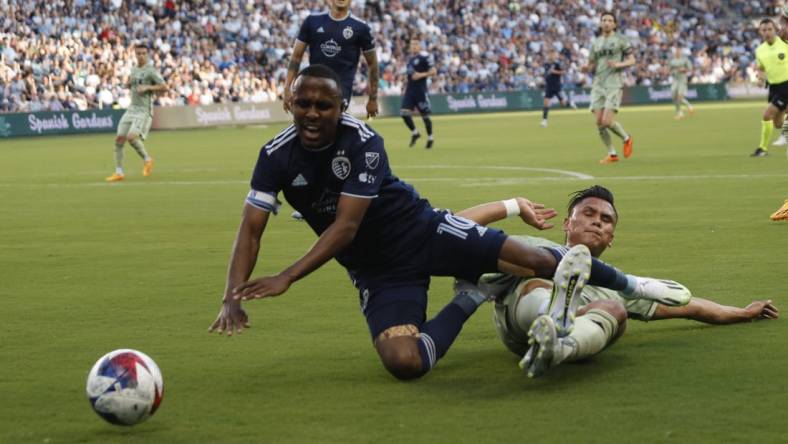 Jun 17, 2023; Kansas City, Kansas, USA; Sporting Kansas City midfielder Gadi Kinda (10) fights for the ball against Los Angeles FC During first half at Children's Mercy Park. Mandatory Credit: Kylie Graham-USA TODAY Sports