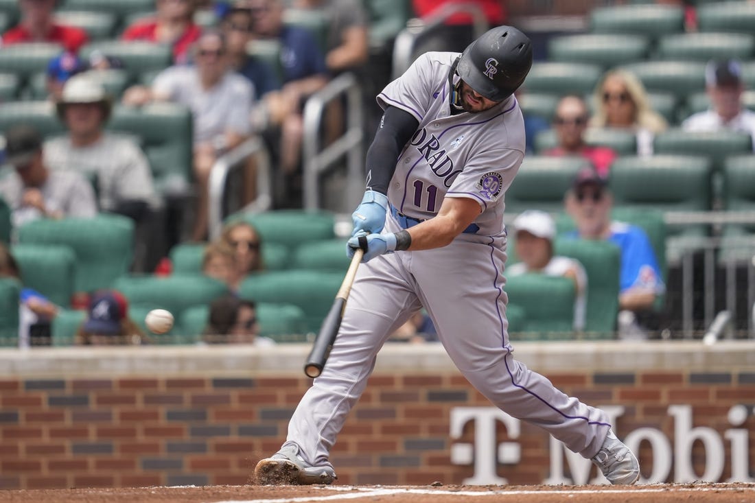 Jun 18, 2023; Cumberland, Georgia, USA; Colorado Rockies first baseman Mike Moustakas (11) singles against the Atlanta Braves during the second inning at Truist Park. Mandatory Credit: Dale Zanine-USA TODAY Sports