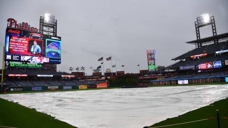 Jun 21, 2023; Philadelphia, Pennsylvania, USA; Tarp covers the infield during rain delay before start of game Philadelphia Phillies and Atlanta Braves at Citizens Bank Park. Mandatory Credit: Eric Hartline-USA TODAY Sports