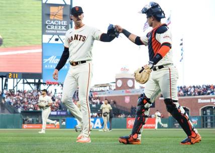 Jun 21, 2023; San Francisco, California, USA; San Francisco Giants relief pitcher Sean Hjelle (64) celebrates with catcher Black Sabol (2) after striking out a San Diego Padres batter during the fifth inning at Oracle Park. Mandatory Credit: Kelley L Cox-USA TODAY Sports