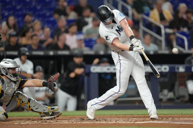 Miami Marlins first baseman Garrett Cooper (26) throws from the