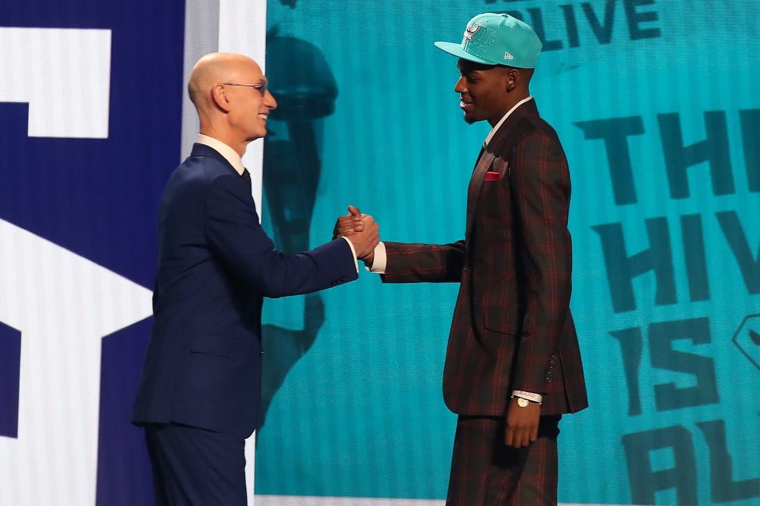 Jun 22, 2023; Brooklyn, NY, USA; Brandon Miller (Alabama) is greeted by NBA commissioner Adam Silver after being selected second by the Charlotte Hornets in the first round of the 2023 NBA Draft at Barclays Arena. Mandatory Credit: Wendell Cruz-USA TODAY Sports