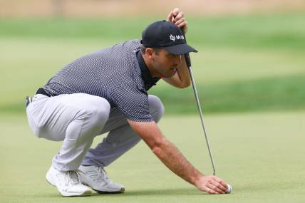 Jun 23, 2023; Cromwell, Connecticut, USA; Denny McCarthy lines up a putt on the seventh green during the second round of the Travelers Championship golf tournament. Mandatory Credit: Vincent Carchietta-USA TODAY Sports