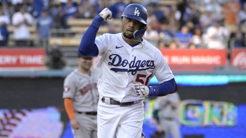 Jun 23, 2023; Los Angeles, California, USA; Los Angeles Dodgers right fielder Mookie Betts (50) pumps his fist as he rounds the bases after hitting a solo home run in the first inning against the Houston Astros at Dodger Stadium. Mandatory Credit: Jayne Kamin-Oncea-USA TODAY Sports