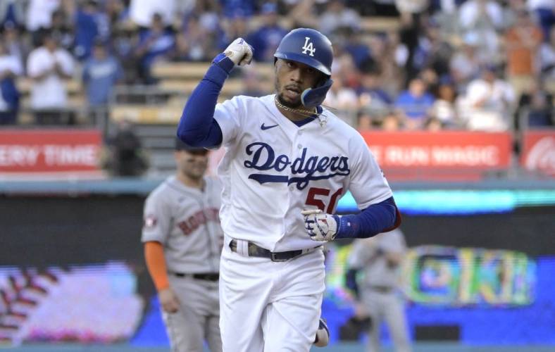 Jun 23, 2023; Los Angeles, California, USA; Los Angeles Dodgers right fielder Mookie Betts (50) pumps his fist as he rounds the bases after hitting a solo home run in the first inning against the Houston Astros at Dodger Stadium. Mandatory Credit: Jayne Kamin-Oncea-USA TODAY Sports