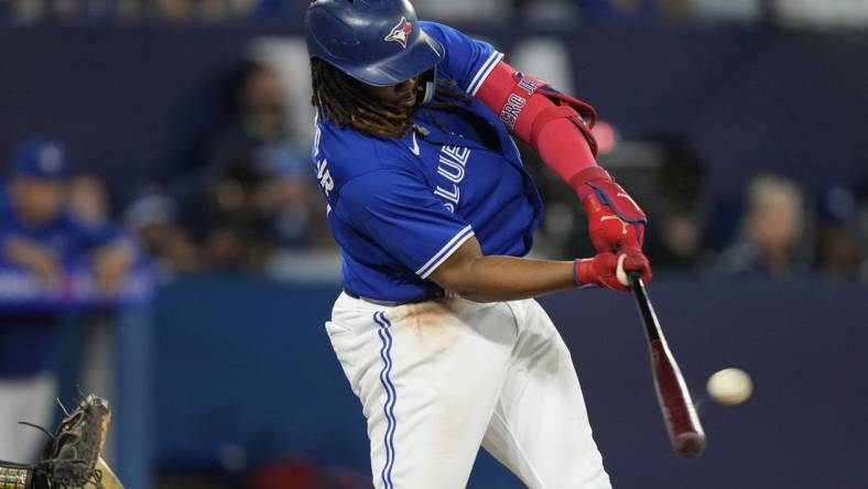 Jun 24, 2023; Toronto, Ontario, CAN; Toronto Blue Jays first baseman Vladimir Guerrero Jr. (27) hits a two run home run against the Oakland Athletics during the sixth inning at Rogers Centre. Mandatory Credit: John E. Sokolowski-USA TODAY Sports