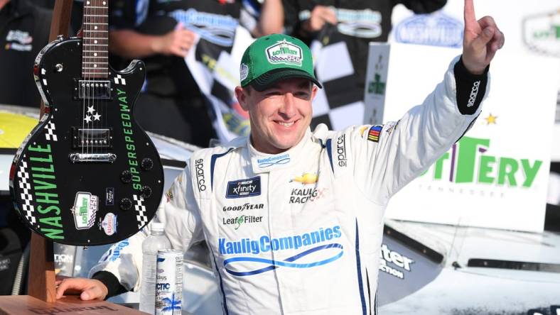 Jun 24, 2023; Nashville, Tennessee, USA; NASCAR Xfinity Series driver AJ Allmendinger (10) and his team celebrate winning the Tennessee Lottery 250 at Nashville Superspeedway. Mandatory Credit: Christopher Hanewinckel-USA TODAY Sports