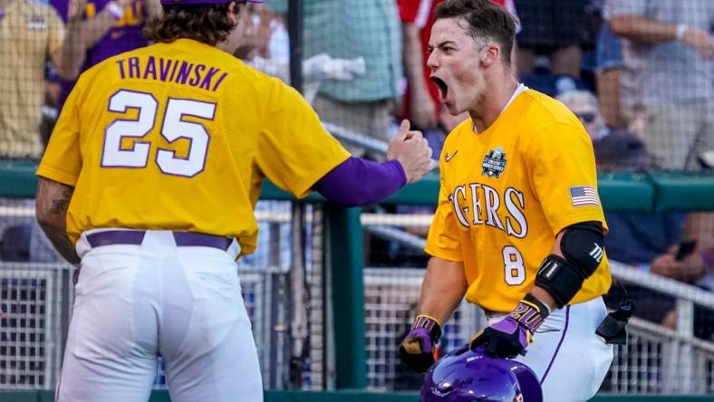 Jun 24, 2023; Omaha, NE, USA; LSU Tigers second baseman Gavin Dugas (8) celebrates with catcher Hayden Travinski (25) after scoring a home run against the Florida Gators during the third inning at Charles Schwab Field Omaha. Mandatory Credit: Dylan Widger-USA TODAY Sports