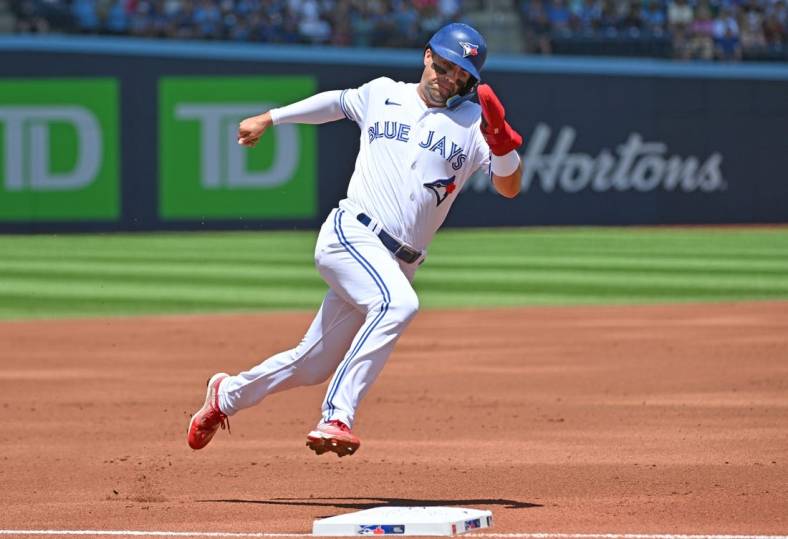 Jun 25, 2023; Toronto, Ontario, CAN; Toronto Blue Jays left fielder Whit Merrifield (15) rounds third base as he scores a run against the Oakland Athletics in the first inning at Rogers Centre. Mandatory Credit: Dan Hamilton-USA TODAY Sports