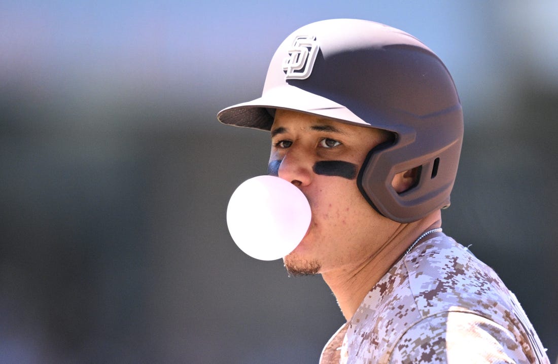 Jun 25, 2023; San Diego, California, USA; San Diego Padres third baseman Manny Machado (13) blows a bubble-gum bubble during the sixth inning against the Washington Nationals at Petco Park. Mandatory Credit: Orlando Ramirez-USA TODAY Sports