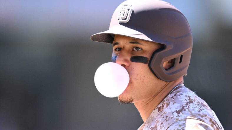 Jun 25, 2023; San Diego, California, USA; San Diego Padres third baseman Manny Machado (13) blows a bubble-gum bubble during the sixth inning against the Washington Nationals at Petco Park. Mandatory Credit: Orlando Ramirez-USA TODAY Sports