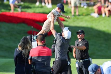 Jun 25, 2023; Cromwell, Connecticut, USA; Keegan Bradley celebrates with his son Logan James after winning the Travelers Championship golf tournament. Mandatory Credit: Vincent Carchietta-USA TODAY Sports