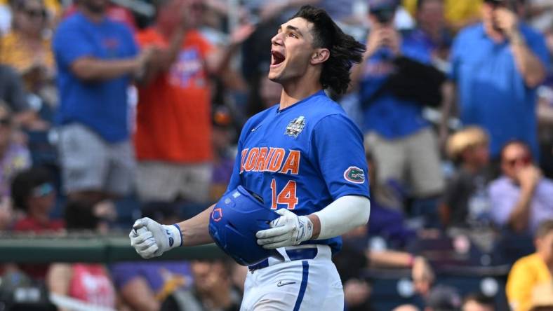 Jun 25, 2023; Omaha, NE, USA;  Florida Gators first baseman Jac Caglianone (14) celebrates hitting a home run against the LSU Tigers in the eighth inning at Charles Schwab Field Omaha. Mandatory Credit: Steven Branscombe-USA TODAY Sports