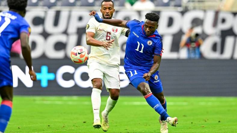 Jun 25, 2023; Houston, Texas, USA; Haiti forward Derrick Etienne (11) and Qatar midfielder Ahmed Abdoulla (6) battle for possession during the first half at NRG Stadium. Mandatory Credit: Maria Lysaker-USA TODAY Sports