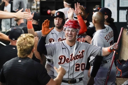 Jun 29, 2023; Arlington, Texas, USA; Detroit Tigers first baseman Spencer Torkelson (20) is greeted in the dugout by teammates and presented with a hockey helmet and stick after hitting a three run home run during the eighth inning against the Texas Rangers at Globe Life Field. Mandatory Credit: Raymond Carlin III-USA TODAY Sports