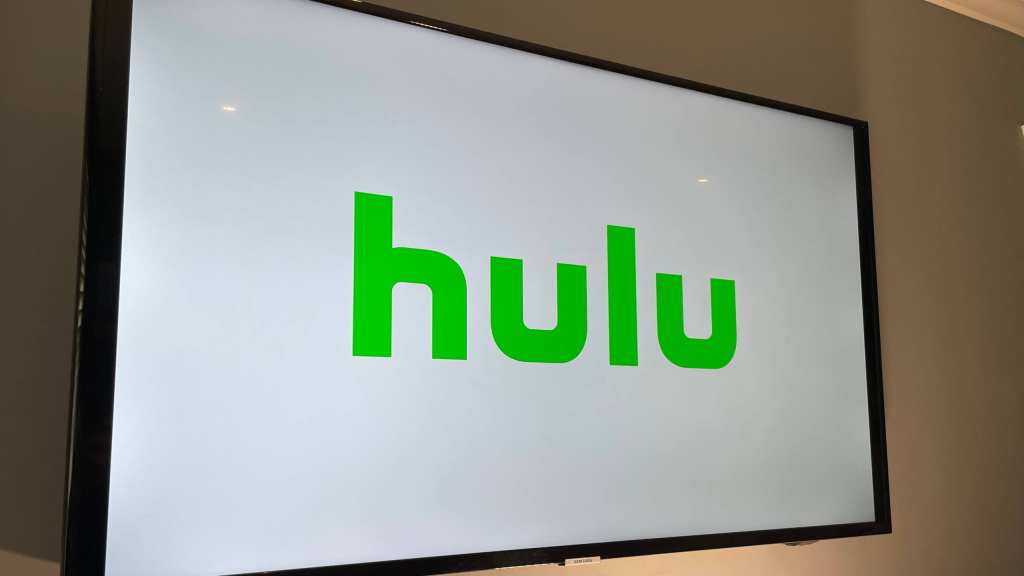 Mounted TV showing the Hulu logo load screen with white background