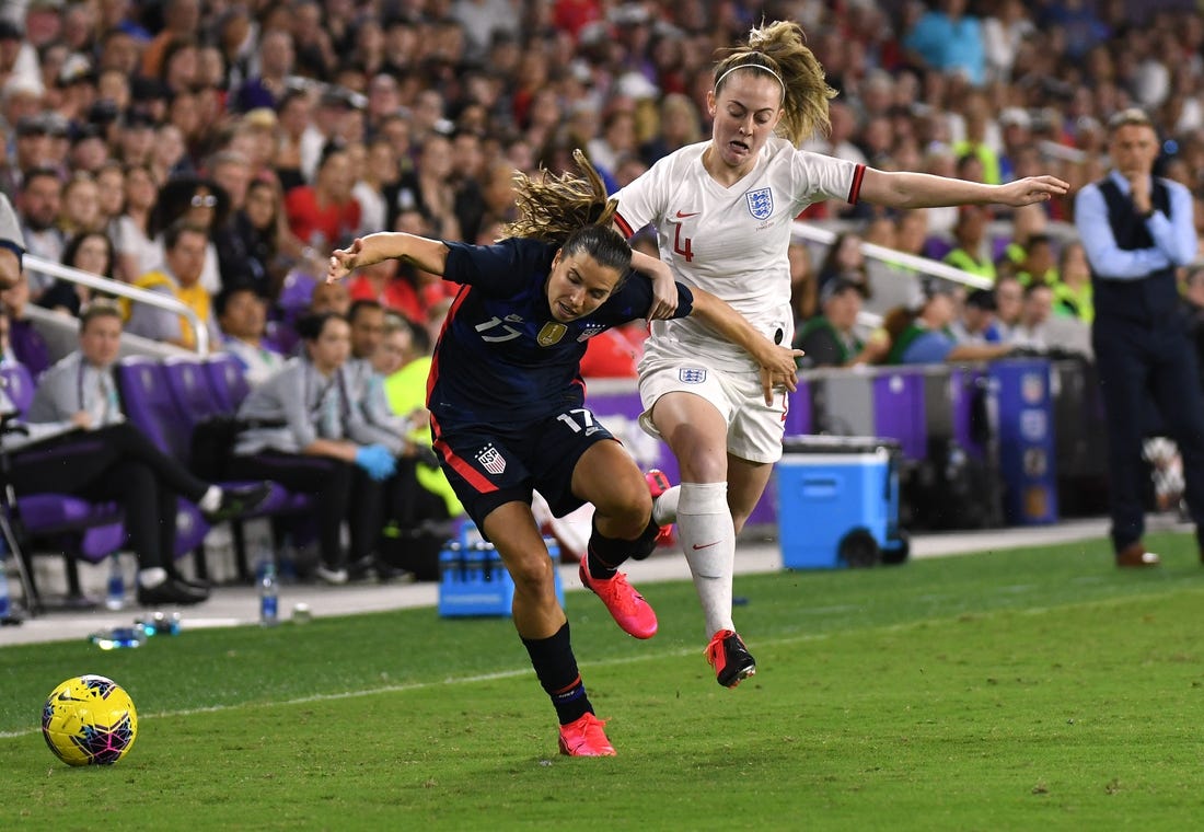Mar 5, 2020; Orlando, Florida, USA; Team USA forward Tobin Heath (17) and Team England midfielder Keira Walsh (4) chase down the loose ball in the first half during the She Believes Cup soccer series at Exploria Stadium. Mandatory Credit: Jonathan Dyer-USA TODAY Sports