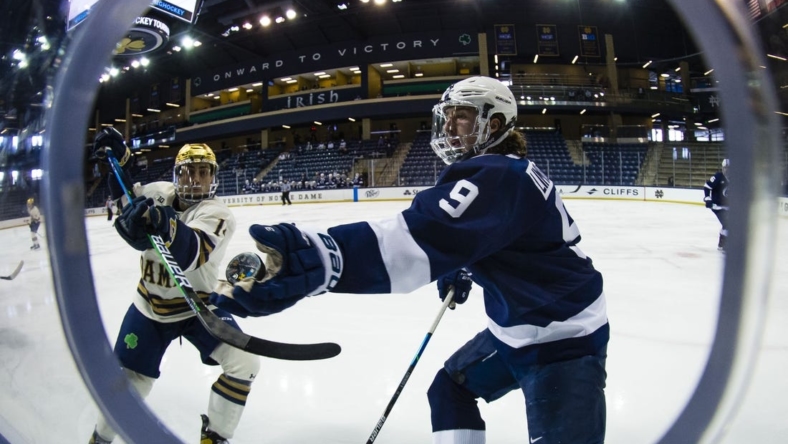 Mar 14, 2021; South Bend, Indiana, USA; Penn State's Alex Limoges (9) reaches out to grab a puck as Notre Dame s Jesse Lansdell (14) defends at the Compton Family Ice Arena. Mandatory Credit: Michael Caterina/South Bend Tribune-USA TODAY NETWORK