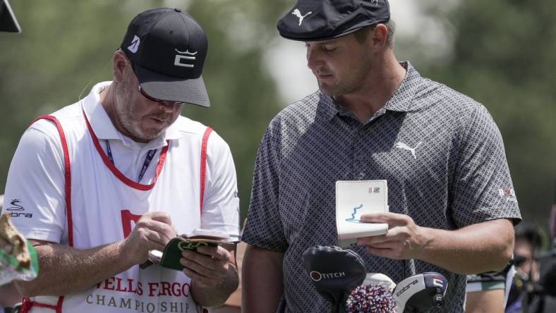 May 6, 2021; Charlotte, North Carolina, USA;  Bryson DeChambeau talks with his caddie Tim Tucker during the first round of the Wells Fargo Championship golf tournament. Mandatory Credit: Jim Dedmon-USA TODAY Sports