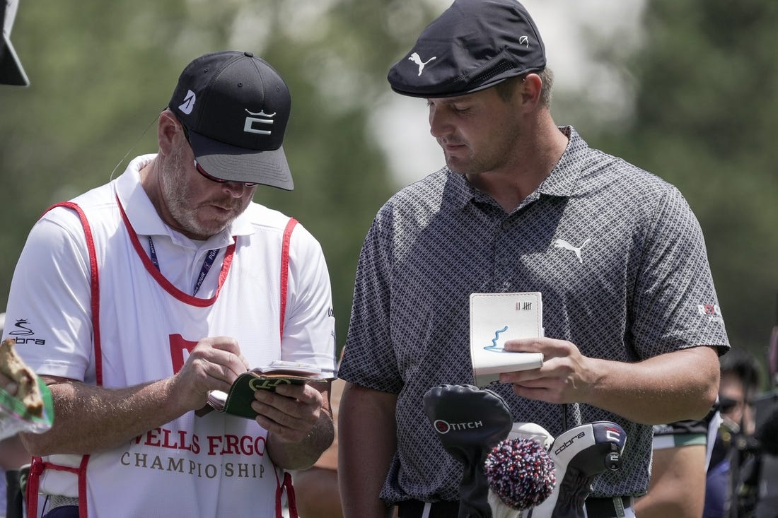 May 6, 2021; Charlotte, North Carolina, USA;  Bryson DeChambeau talks with his caddie Tim Tucker during the first round of the Wells Fargo Championship golf tournament. Mandatory Credit: Jim Dedmon-USA TODAY Sports