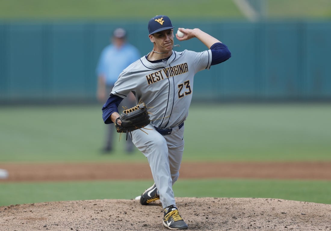 May 26, 2021; Oklahoma City, Oklahoma, USA; West Virginia pitcher Jackson Wolf (23) delivers a pitch to Texas during the Big 12 Conference Baseball Tournament at Chickasaw Bricktown Ballpark. Mandatory Credit: Alonzo Adams-USA TODAY Sports