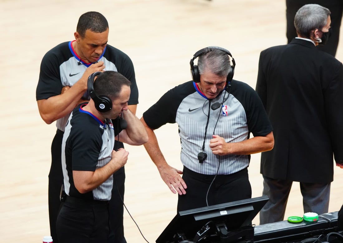 Jun 22, 2021; Phoenix, Arizona, USA; NBA referee Scott Foster (right) with Kane Fitzgerald and Curtis Blair during a video review in the Phoenix Suns against the Los Angeles Clippers during game two of the Western Conference Finals for the 2021 NBA Playoffs at Phoenix Suns Arena. Mandatory Credit: Mark J. Rebilas-USA TODAY Sports