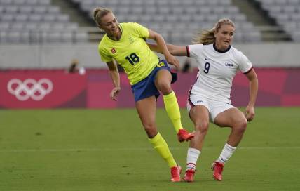 Sweden forward Fridolina Rolfo (18) collides with United States midfielder Lindsey Horan (9) during the first half in Group G play during the Tokyo 2020 Olympic Summer Games at Tokyo Stadium. Mandatory Credit: Jack Gruber-USA TODAY Network