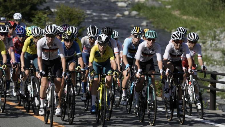 Jul 25, 2021; Shizuoka, Japan; The peloton climbs next to the Doshi River during the Tokyo 2020 Olympic Summer Games at Fuji Speedway. Mandatory Credit: Andrew P. Scott-USA TODAY Network