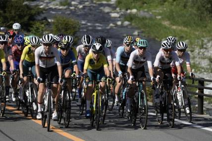 Jul 25, 2021; Shizuoka, Japan; The peloton climbs next to the Doshi River during the Tokyo 2020 Olympic Summer Games at Fuji Speedway. Mandatory Credit: Andrew P. Scott-USA TODAY Network