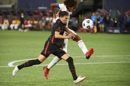 Aug 21, 2021; Portland, OR, USA;  Olympique Lyonnais defender Wendie Renard (3) bates for the ball against Portland Thorns FC forward Christine Sinclair (12) during the second half at the Women s International Champions Cup at Providence Park. Portland won 1-0. Mandatory Credit: Troy Wayrynen-USA TODAY Sports