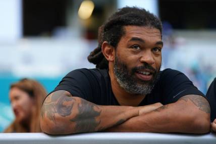 Nov 28, 2021; Miami Gardens, Florida, USA;  Carolina Panthers former defensive end Julius Peppers sits in the stands prior to the game between the Miami Dolphins and the Carolina Panthers at Hard Rock Stadium. Mandatory Credit: Jasen Vinlove-USA TODAY Sports