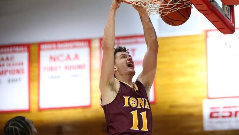 Iona's Quinn Slazinski slam dunks on Marist's Victor Enoh during Wednesday's game in Poughkeepsie on December 1, 2021.

Marist Vs Iona Basketball