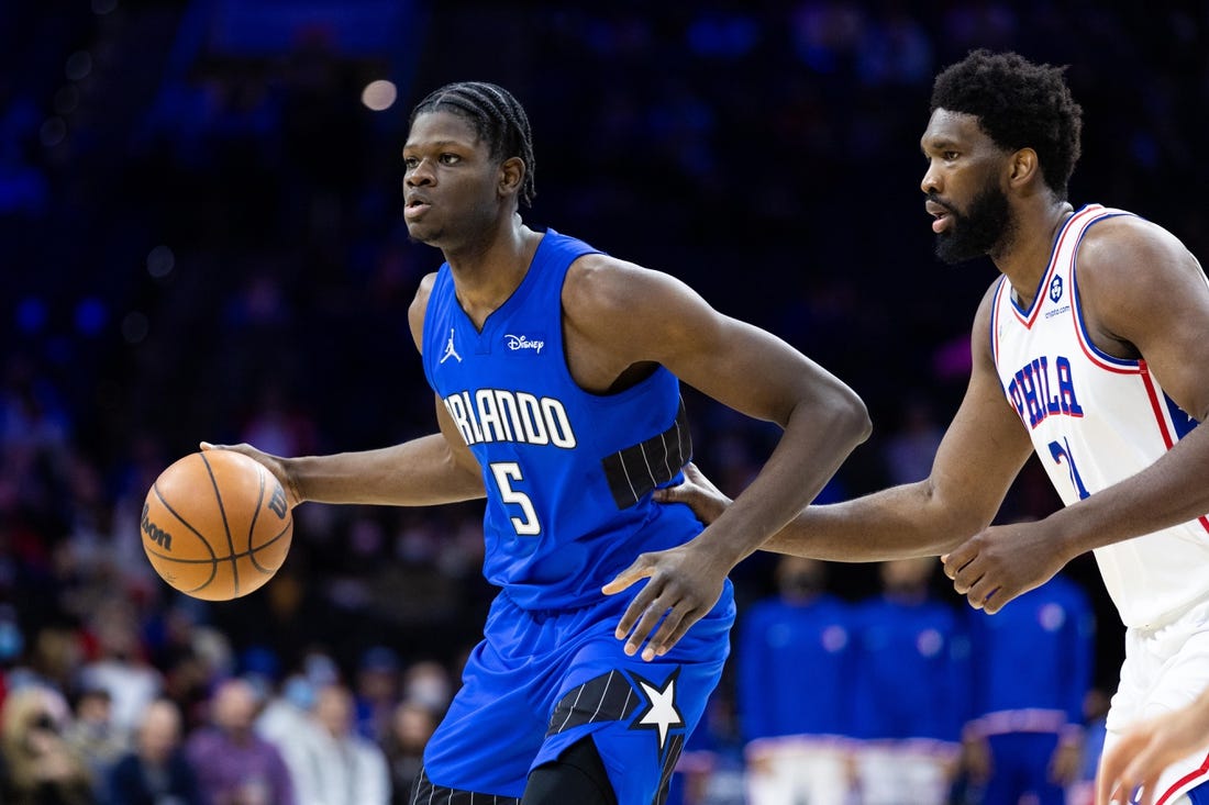 Jan 19, 2022; Philadelphia, Pennsylvania, USA; Orlando Magic center Mo Bamba (5) dribbles the ball against Philadelphia 76ers center Joel Embiid (21) during the third quarter at Wells Fargo Center. Mandatory Credit: Bill Streicher-USA TODAY Sports