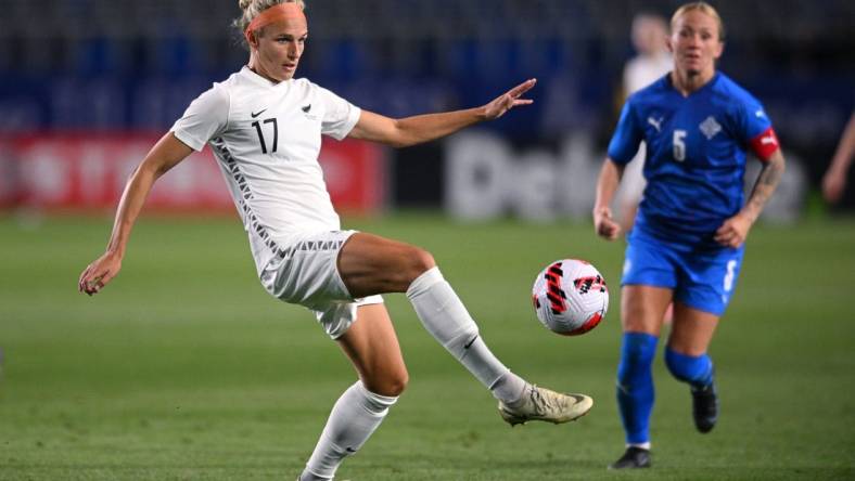 Feb 17, 2022; Carson, California, USA; New Zealand forward Hannah Wilkinson (17) passes the ball ahead of Iceland midfielder Gunnhildur Yrsa Jonsdottir (5) in the second half during a 2022 SheBelieves Cup international soccer match at Dignity Health Sports Park. Mandatory Credit: Orlando Ramirez-USA TODAY Sports