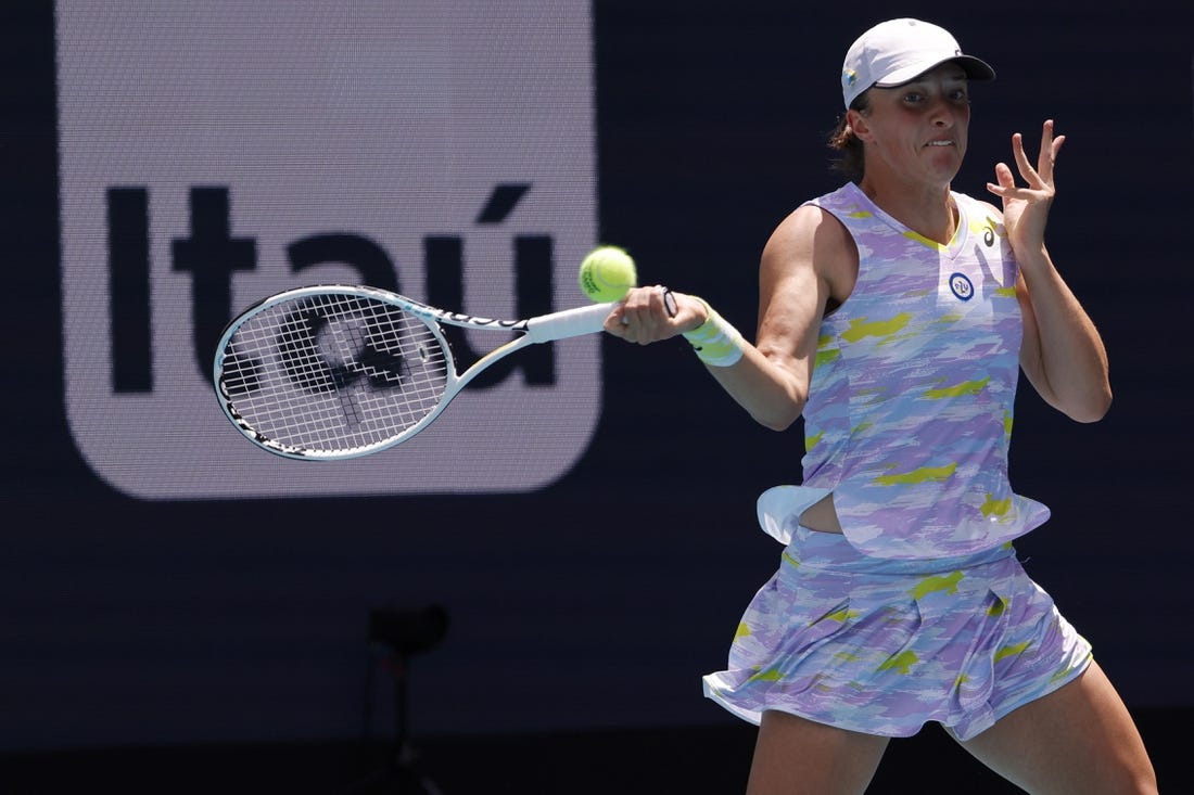 Apr 2, 2022; Miami Gardens, FL, USA;  Iga Swiatek (POL) hits a forehand against Naomi Osaka (JPN)(not pictured) in the women's singles final in the Miami Open at Hard Rock Stadium. Mandatory Credit: Geoff Burke-USA TODAY Sports