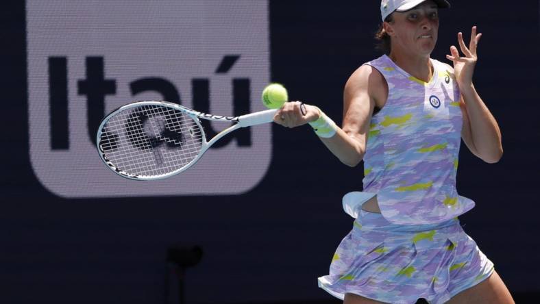 Apr 2, 2022; Miami Gardens, FL, USA;  Iga Swiatek (POL) hits a forehand against Naomi Osaka (JPN)(not pictured) in the women's singles final in the Miami Open at Hard Rock Stadium. Mandatory Credit: Geoff Burke-USA TODAY Sports