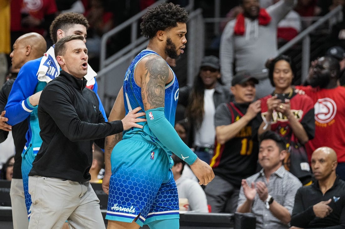 Apr 13, 2022; Atlanta, Georgia, USA; Charlotte Hornets forward Miles Bridges (0) is restrained after being called for a technical foul and being ejected from the game against the Atlanta Hawks during the second half at State Farm Arena. Mandatory Credit: Dale Zanine-USA TODAY Sports