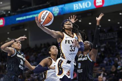 May 24, 2022; Chicago, Illinois, USA; Indiana Fever guard Destanni Henderson (33) goes to the basket against Chicago Sky guard Kahleah Copper (2) during the second half at Wintrust Arena. Mandatory Credit: Kamil Krzaczynski-USA TODAY Sports