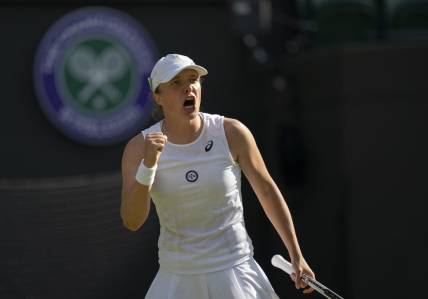 Jun 30, 2022; London, United Kingdom; Iga Swiatek (POL) reacts to a point during her match against Lesley Pattinama Kerkhove (NED) on day four at All England Lawn Tennis and Croquet Club. Mandatory Credit: Susan Mullane-USA TODAY Sports