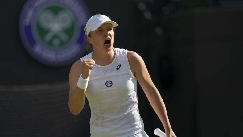 Jun 30, 2022; London, United Kingdom; Iga Swiatek (POL) reacts to a point during her match against Lesley Pattinama Kerkhove (NED) on day four at All England Lawn Tennis and Croquet Club. Mandatory Credit: Susan Mullane-USA TODAY Sports