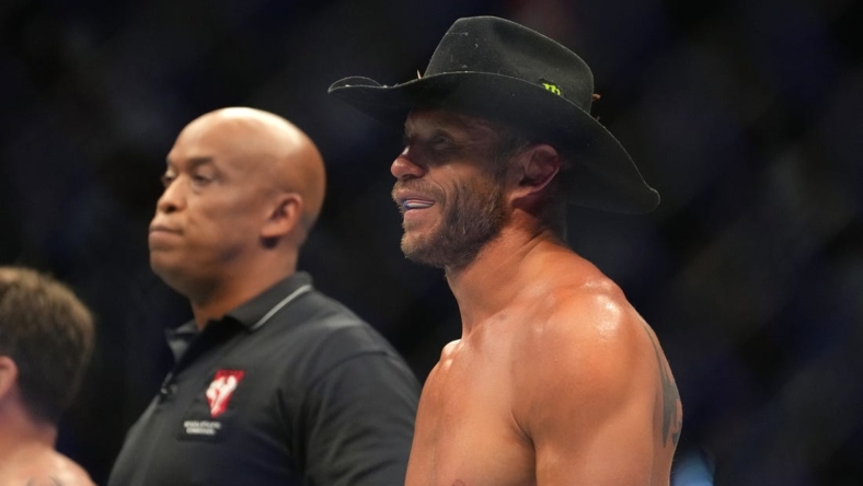 Jul 2, 2022; Las Vegas, Nevada, USA; Donald Cerrone (blue gloves) reacts after a loss to Jim Miller (red gloves) during UFC 276 at T-Mobile Arena. Mandatory Credit: Stephen R. Sylvanie-USA TODAY Sports