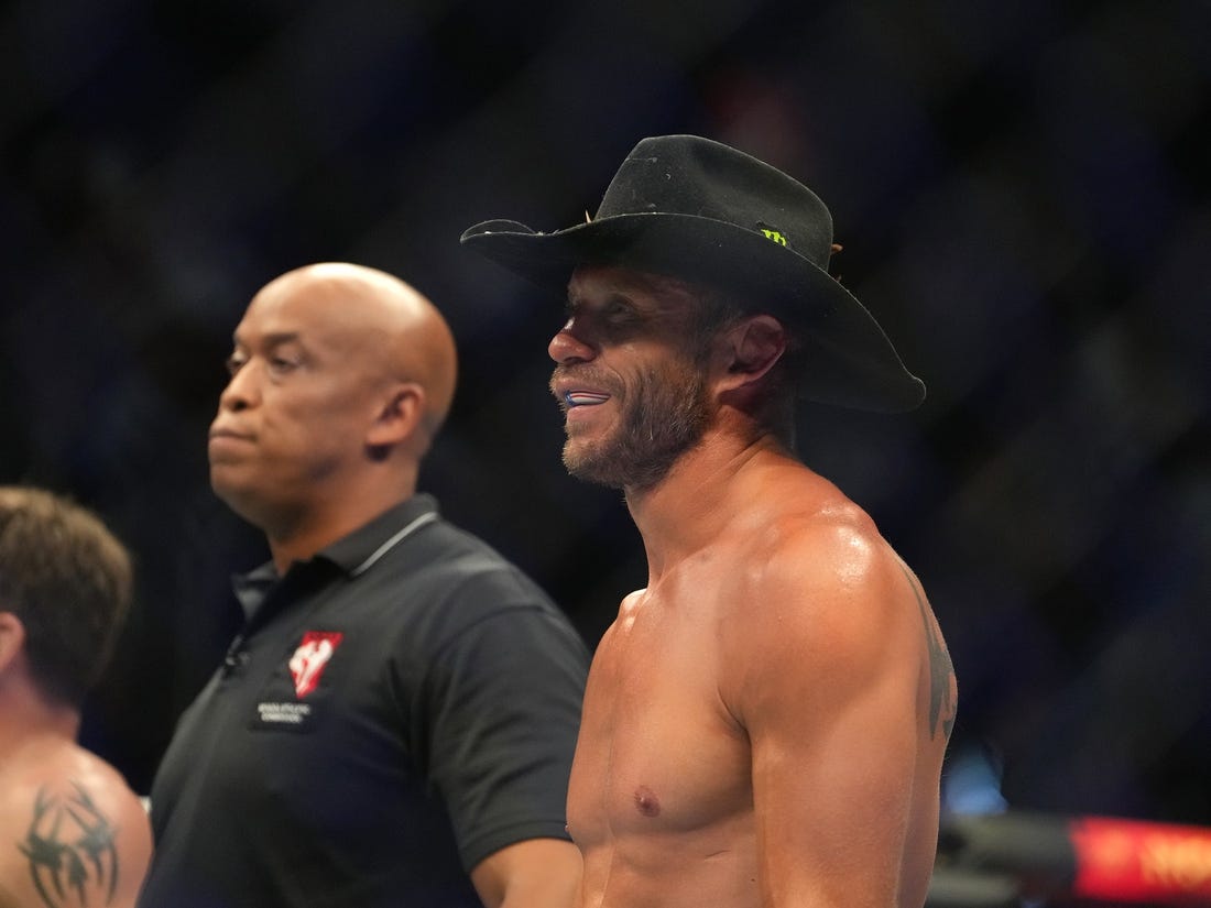 Jul 2, 2022; Las Vegas, Nevada, USA; Donald Cerrone (blue gloves) reacts after a loss to Jim Miller (red gloves) during UFC 276 at T-Mobile Arena. Mandatory Credit: Stephen R. Sylvanie-USA TODAY Sports