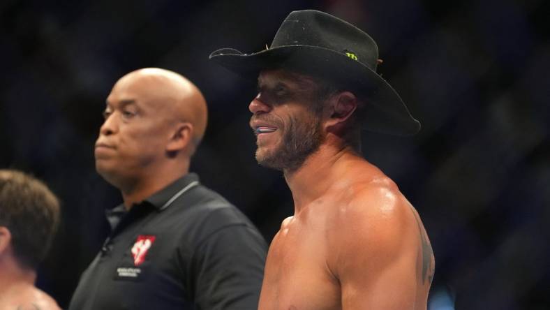 Jul 2, 2022; Las Vegas, Nevada, USA; Donald Cerrone (blue gloves) reacts after a loss to Jim Miller (red gloves) during UFC 276 at T-Mobile Arena. Mandatory Credit: Stephen R. Sylvanie-USA TODAY Sports