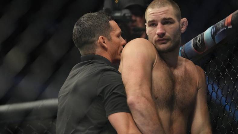 Jul 2, 2022; Las Vegas, Nevada, USA; Sean Strickland (red gloves) reacts after a loss to Alex Pereira (blue gloves) fight in a bout during UFC 276 at T-Mobile Arena. Mandatory Credit: Stephen R. Sylvanie-USA TODAY Sports