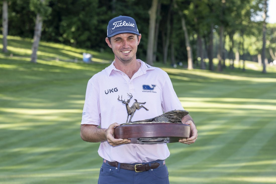 Jul 3, 2022; Silvis, Illinois, USA; J.T. Poston holds the John Deere Classic trophy after winning the John Deere Classic golf tournament. Mandatory Credit: Marc Lebryk-USA TODAY Sports