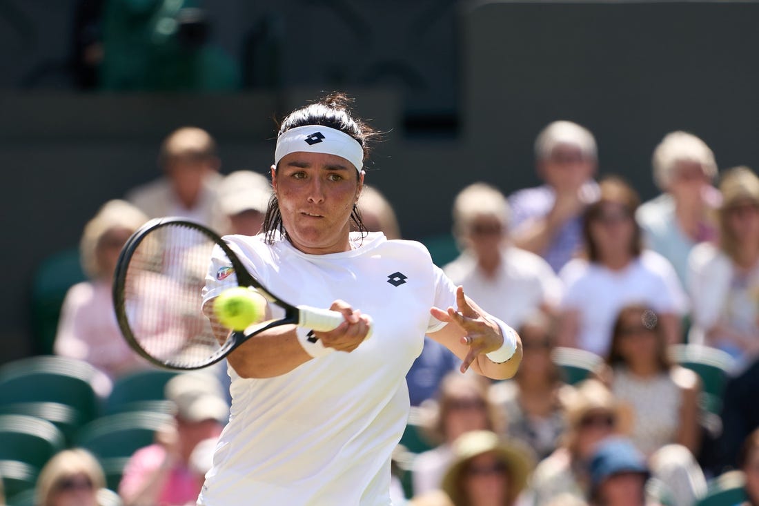 Jul 7, 2022; London, England, United Kingdom;  
Ons Jabeur (TUN) returns a shot during  her semi finals women   s singles match against Tatjana Maria (GER) on Centre court at All England Lawn Tennis and Croquet Club. Mandatory Credit: Peter van den Berg-USA TODAY Sports