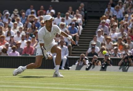 Jul 10, 2022; London, United Kingdom; Novak Djokovic (SRB) returns a shot during the men   s final against Nick Kyrgios (not pictured) on day 14 at All England Lawn Tennis and Croquet Club. Mandatory Credit: Susan Mullane-USA TODAY Sports