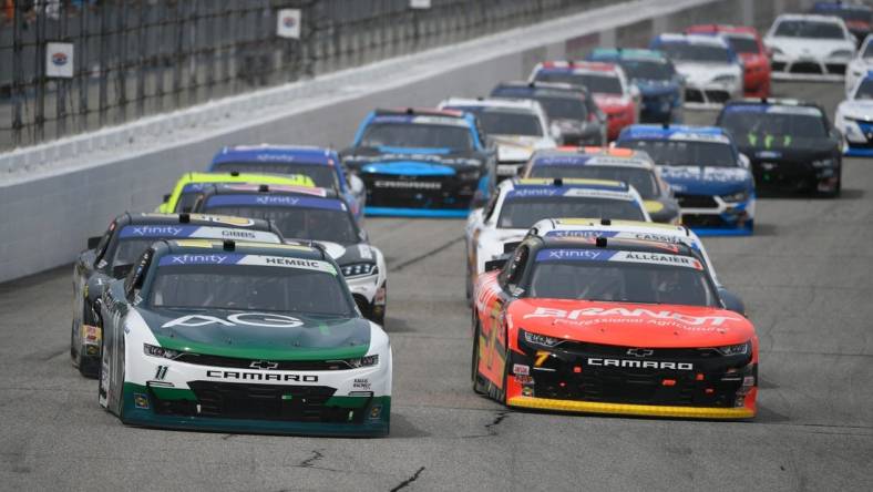 Jul 16, 2022; Loudon, New Hampshire, USA; NASCAR Xfinity Series driver Daniel Hemric (11) and driver Justin Allgaier (7) race during the Crayon 200 at New Hampshire Motor Speedway. Mandatory Credit: Eric Canha-USA TODAY Sports