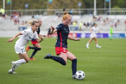 CARY, NC - APRIL 10: Meredith Speck #25 of the NC Courage gives chase as Tori Huster #23 of the Washington Spirit passes the ball during a game between Washington Spirit and North Carolina Courage at Sahlen's Stadium at WakeMed Soccer Park on April 10, 2021 in Cary, North Carolina.