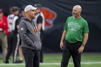 Aug 26, 2022; Vancouver, British Columbia, CAN; BC Lions head coach Rick Campbell (left) and Saskatchewan Roughriders head coach Craig Dickenson talk during warmups at BC Place. Mandatory Credit: Bob Frid-USA TODAY Sports